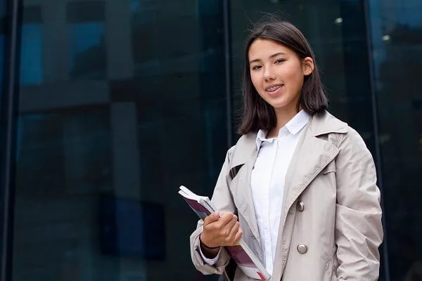 Learner holding English test-preparation materials